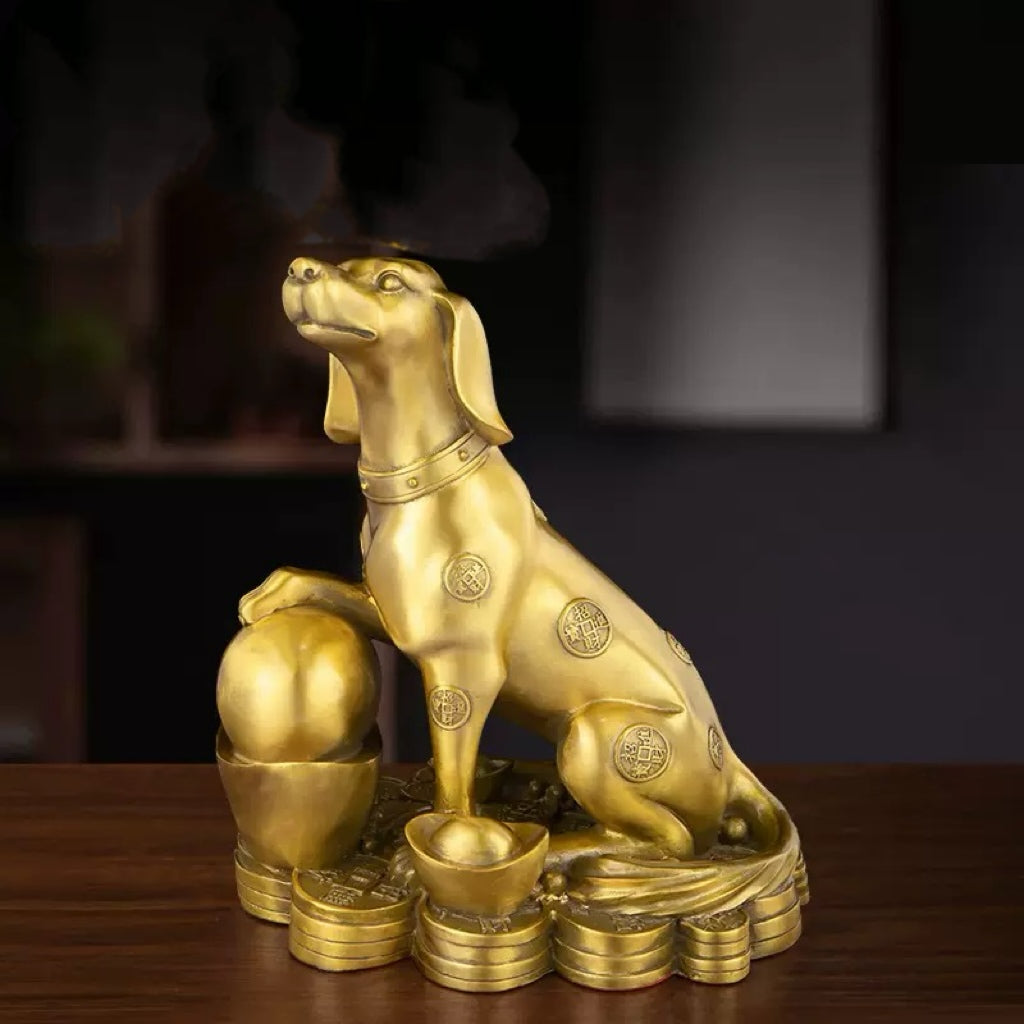 Antique bronze guardian dog statue on wooden desk with gold collar detailing