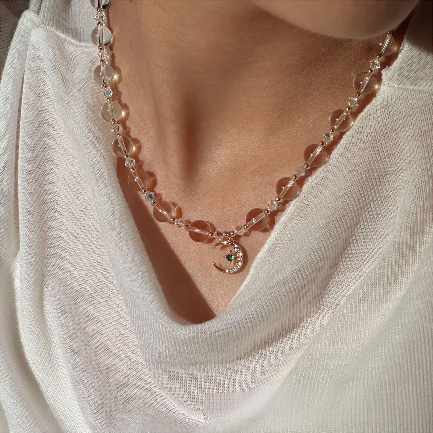 white crystal celestial necklace with sun moon and star pendant