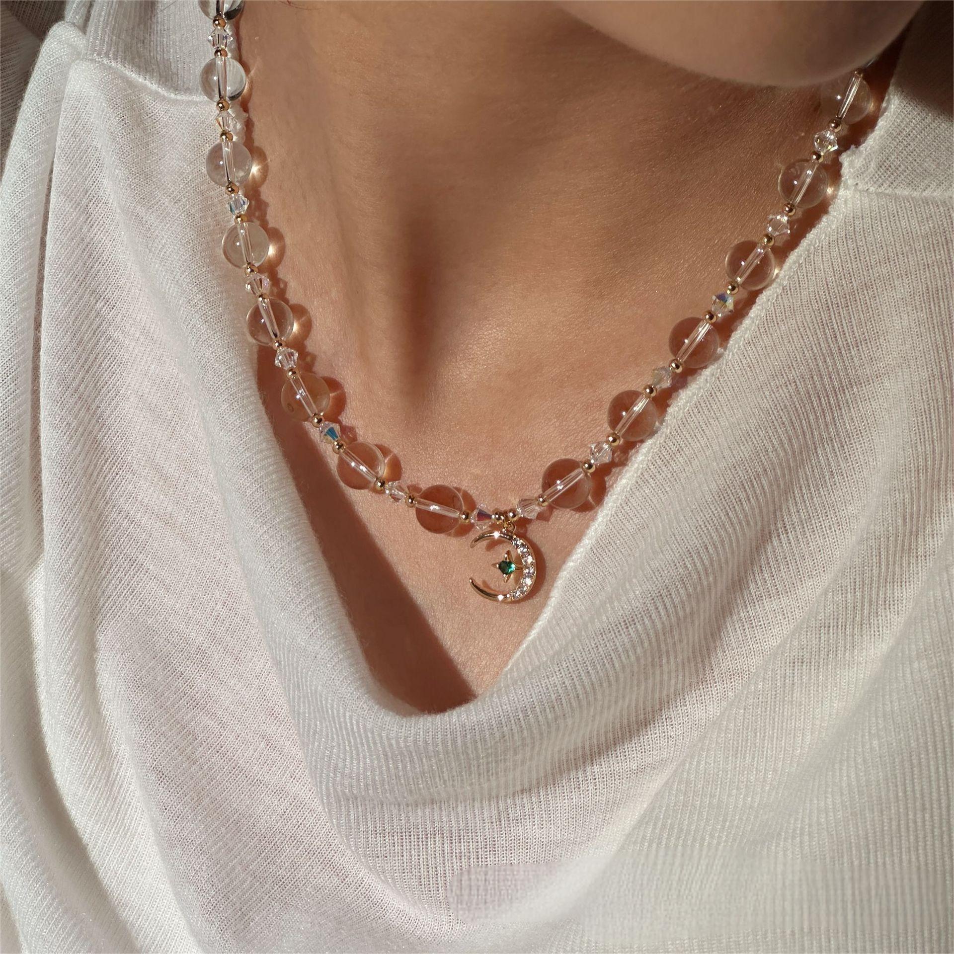 white crystal celestial necklace with sun moon and star pendant
